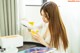 A woman pouring a glass of orange juice into a glass.