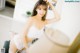 A woman in a white lingerie posing for a picture.