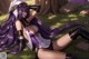 A woman with long purple hair laying on the ground.