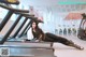 A woman laying on a treadmill in a gym.