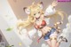 Anime girl with long blonde hair wearing a cat ears outfit.